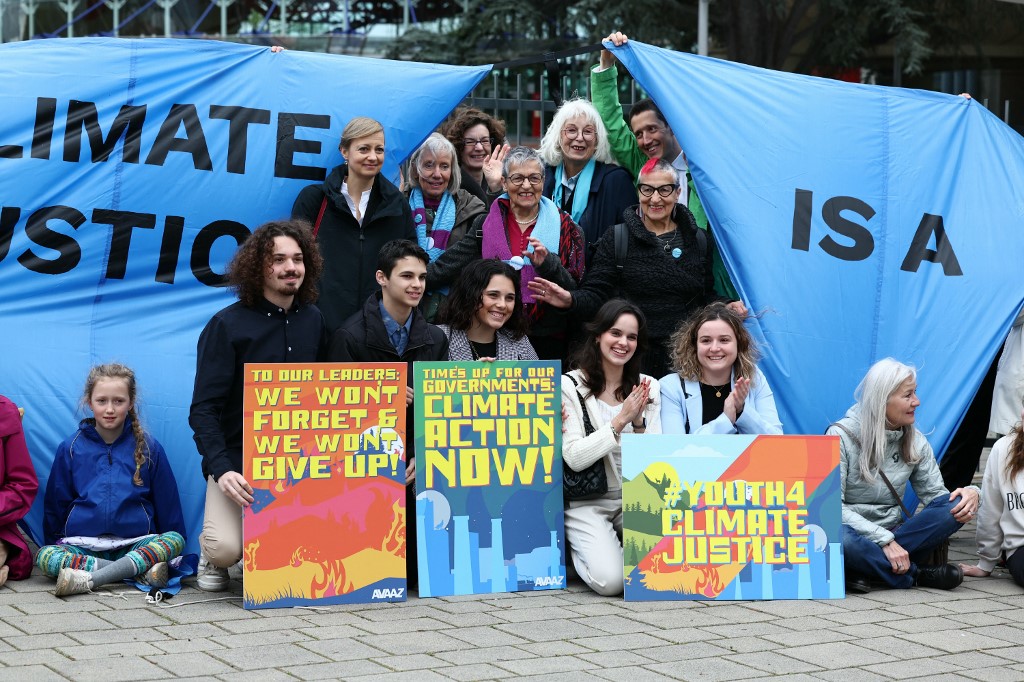 Protesters hold placards during a rally before the European Court of Human Rights (ECHR) decides in three separate cases if states are doing enough in the face of global warming in rulings that could force them to do more, in Strasbourg, eastern France, on April 9, 2024. All three cases accuse European governments of inaction or insufficient action in their measures against global warming. In a sign of the importance of the issue, the cases have all been treated as priority by the Grand Chamber of the ECHR, whose 17 judges can set a potentially crucial legal precedent.